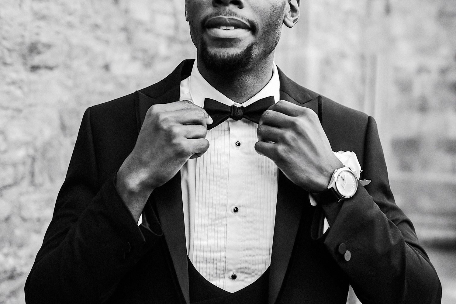 Three cropped detail shots of a black tuxedo with bow tie against a grey background.