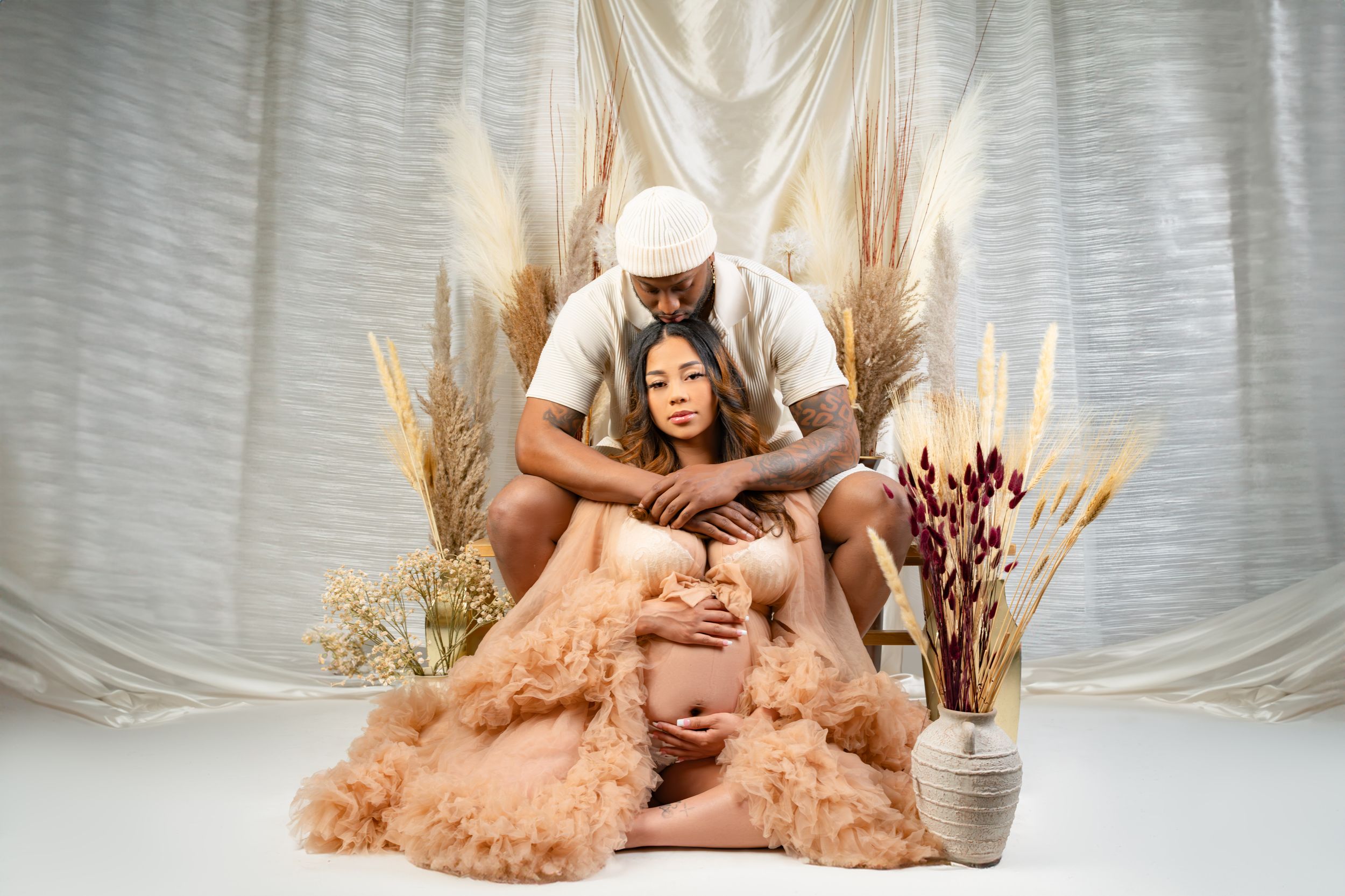 Ethereal boudoir photography series featuring a dreamy setting with soft pink tulle gowns and dried floral arrangements.