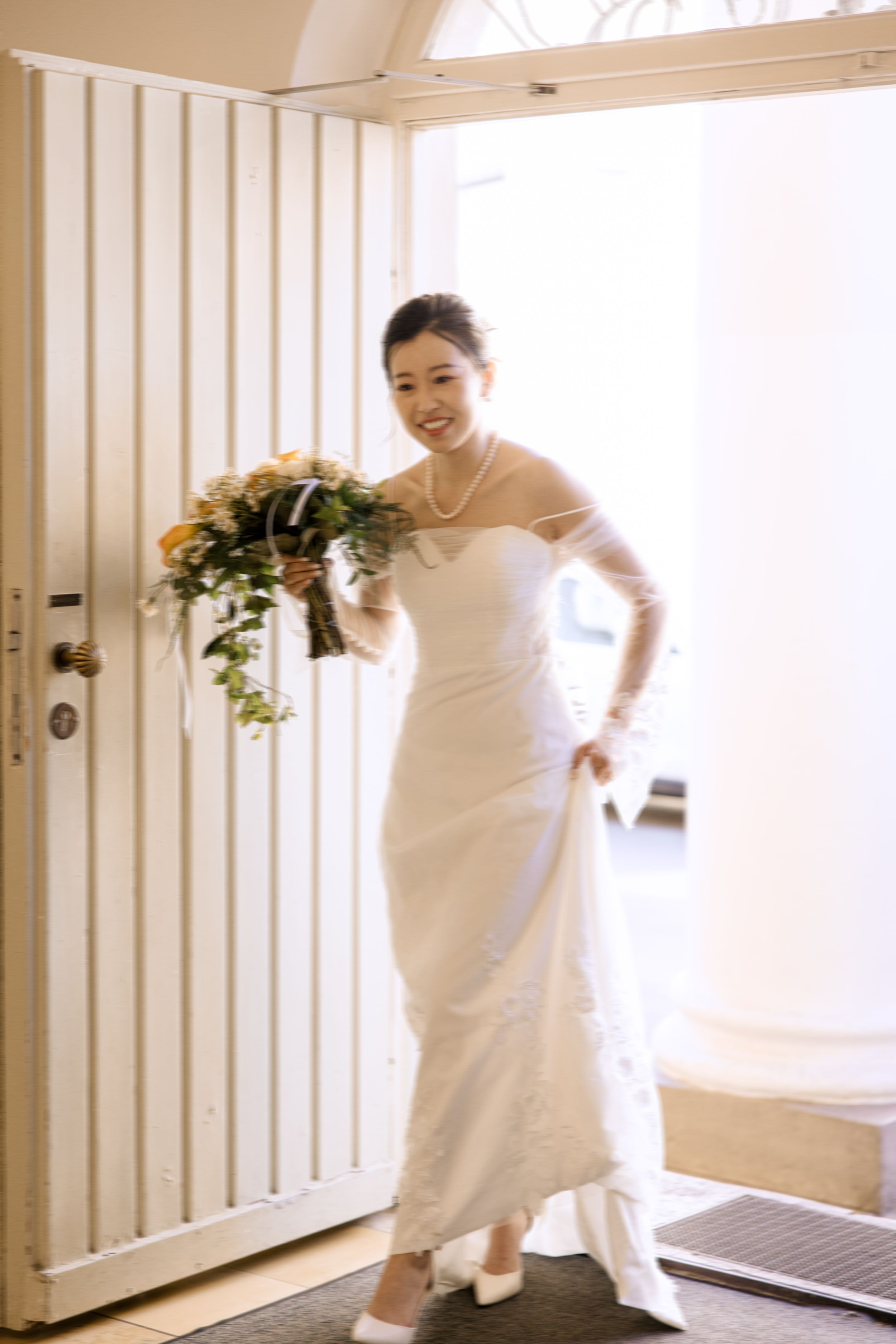 Sequence of joyful bridal portraits in front of white doors and columns.
