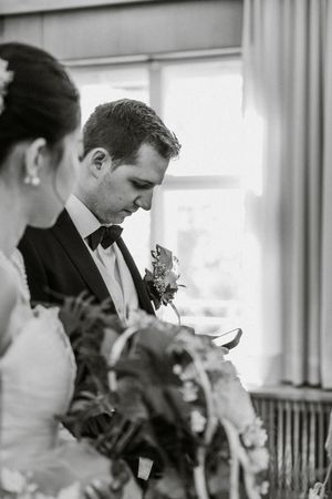 Wedding party members gathered in formal attire with matching bouquets and boutonnieres.
