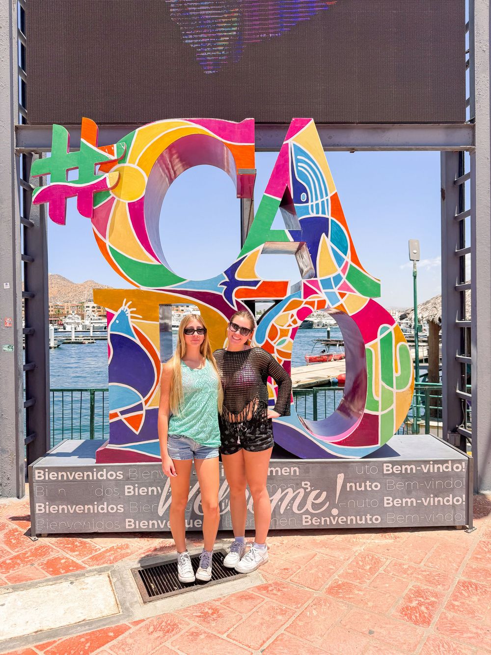 Colorful geometric window displays featuring bold abstract patterns decorate a modern storefront with visitors.