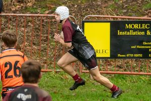Rugby Player runs across the long side of the pitch, scoring a try.