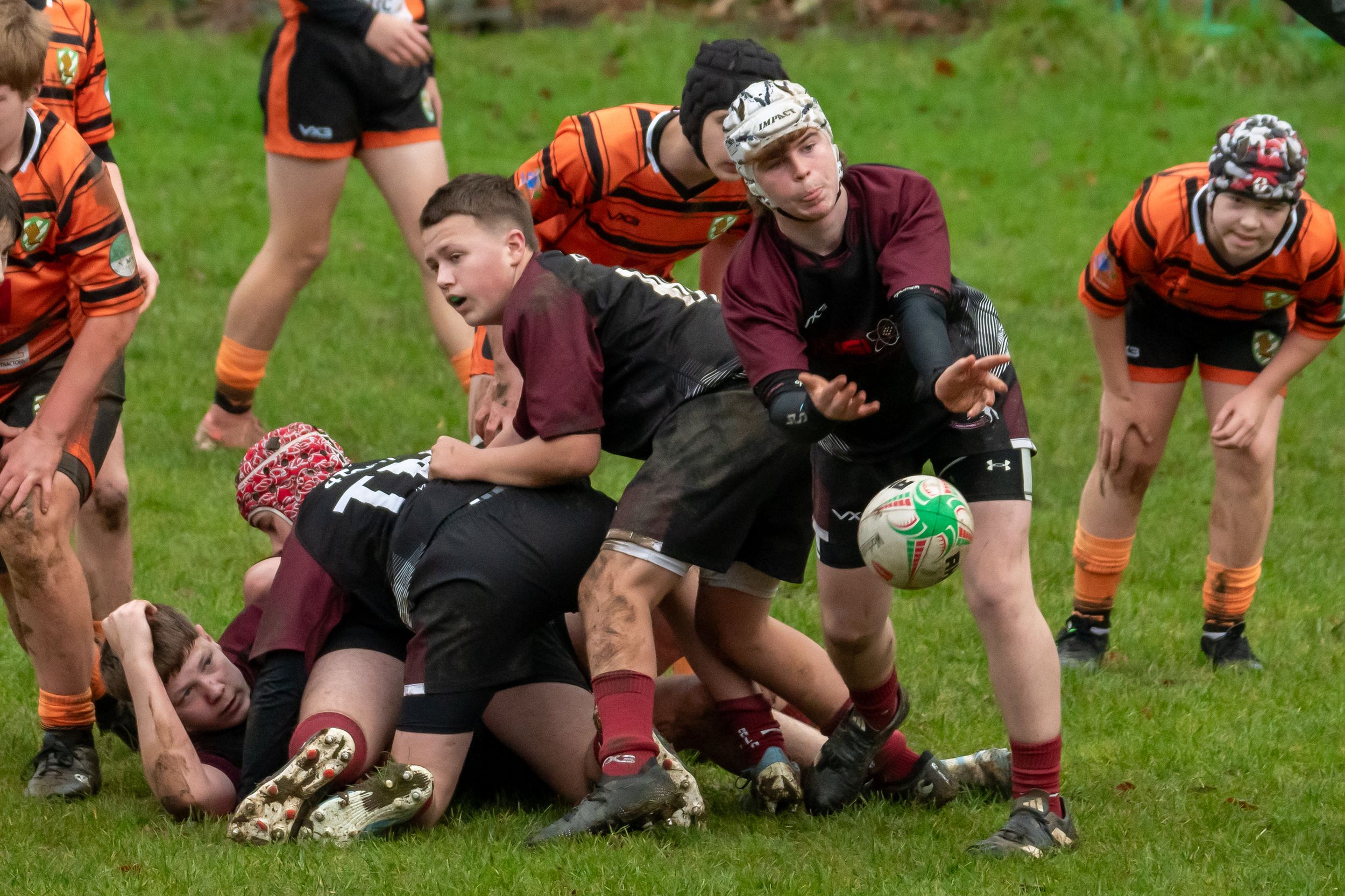Rugby Player throws the ball to another teammate, hoping to get a good result out of the play.