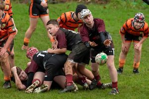 Rugby Player throws the ball to another teammate, hoping to get a good result out of the play.