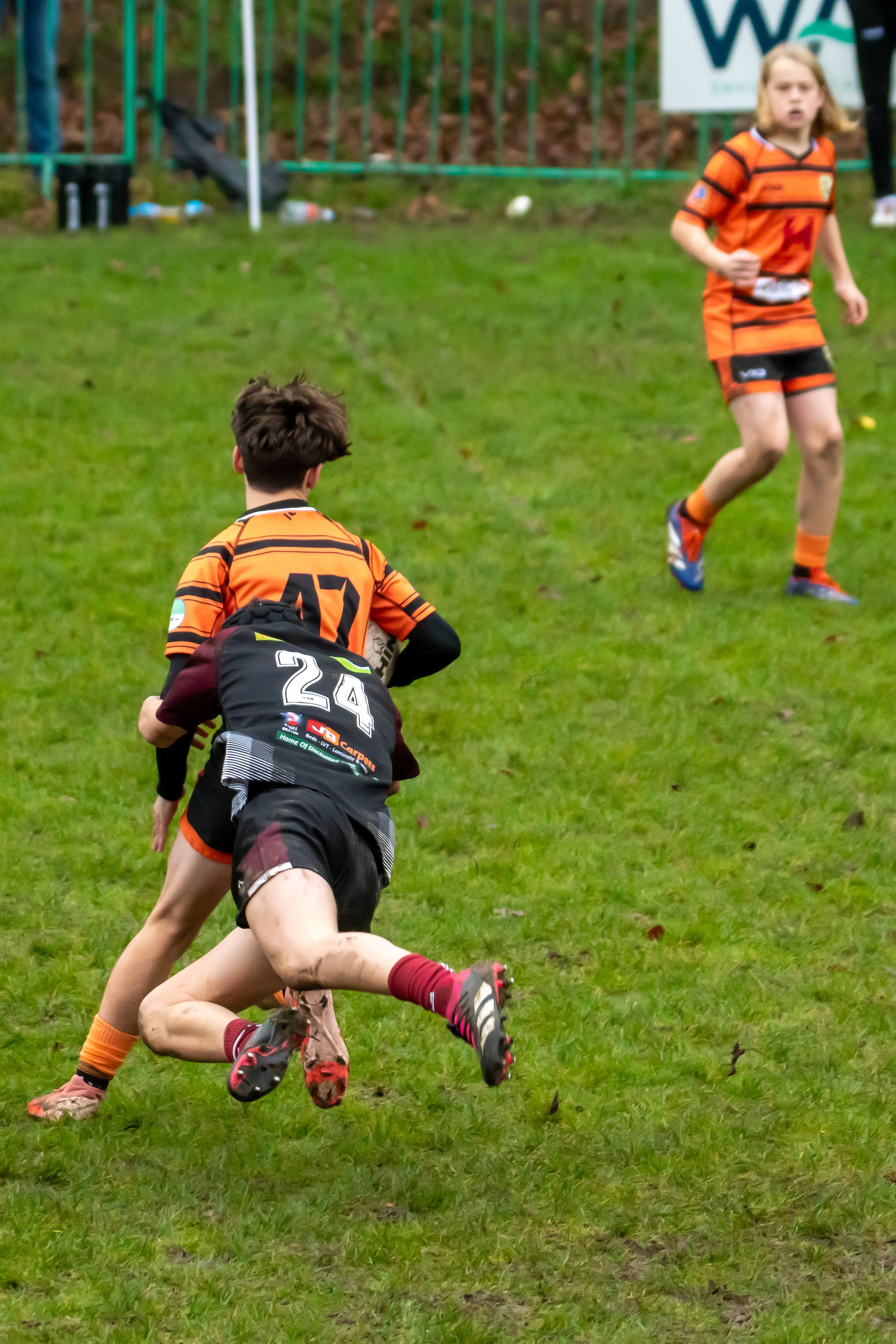 Rugby Player lunges into a tackle, winning their team some time.