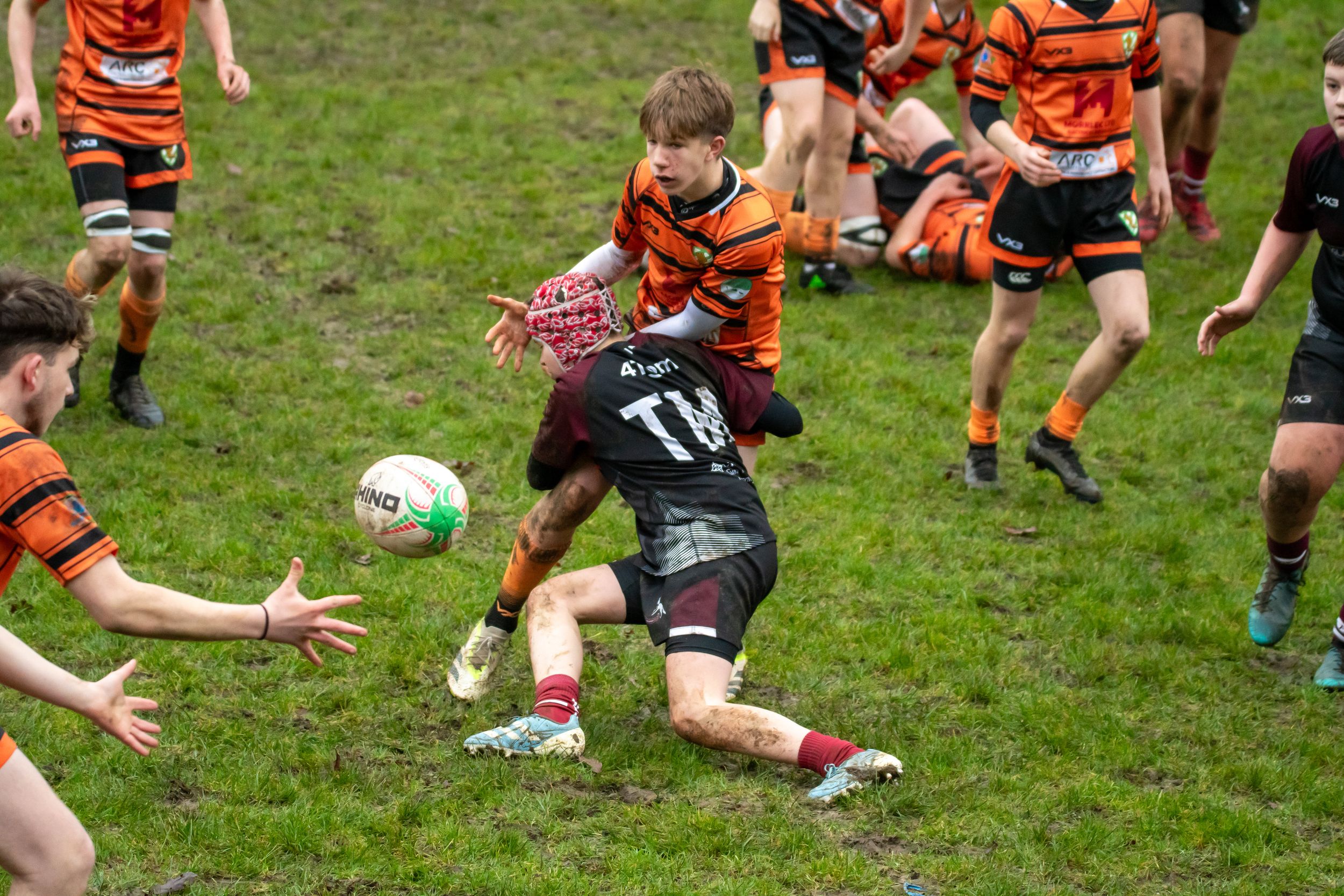 Rugby Player lunges into a tackle, winning their team some time.