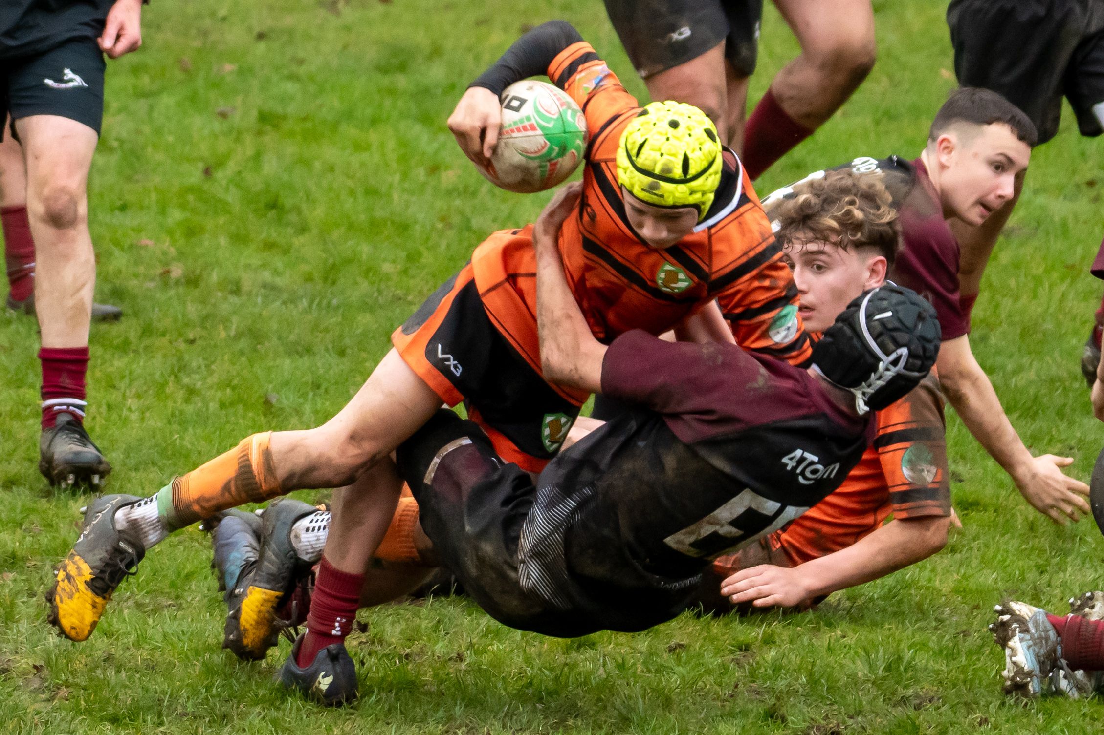 Rugby Player lunges into a tackle, winning their team some time.