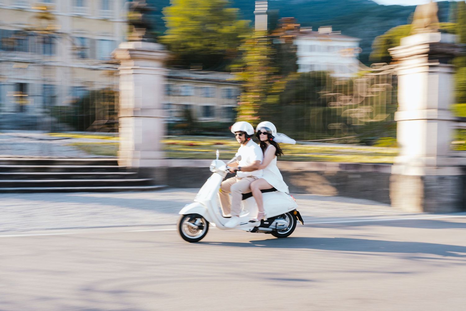 Sequence of motion-blurred images showing cyclist and electric scooter sharing urban pathway during daytime.