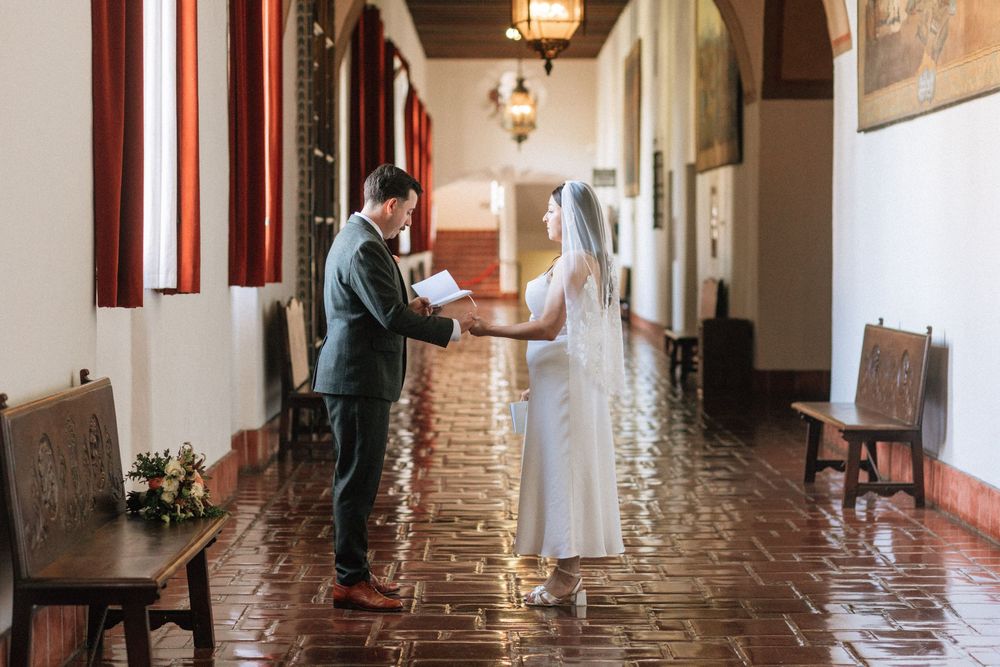 Bride and groom exchanging vows in the Santa Barbara Courthouse Mural Room