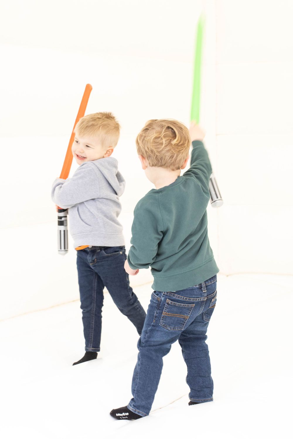 Birthday party celebration with light sabers. Bounce house at birthday party.