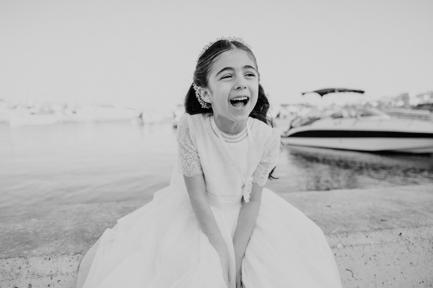 Child playing and laughing outdoors during golden hour photoshoot.