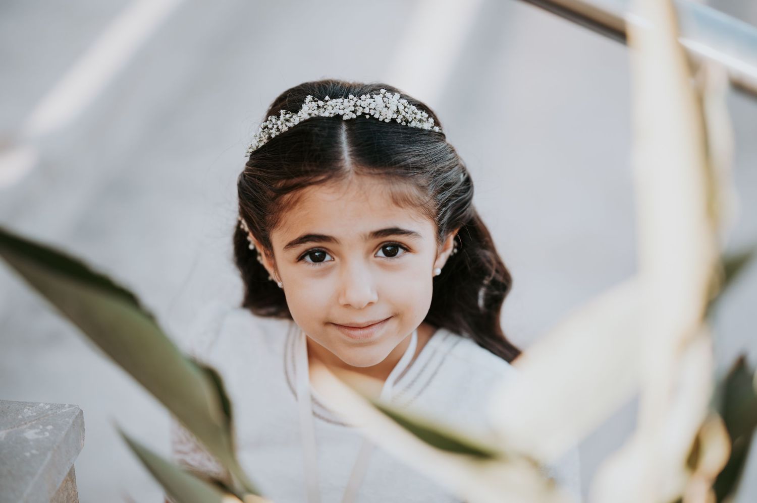 Close-up of delicate crystal headpiece against soft background.