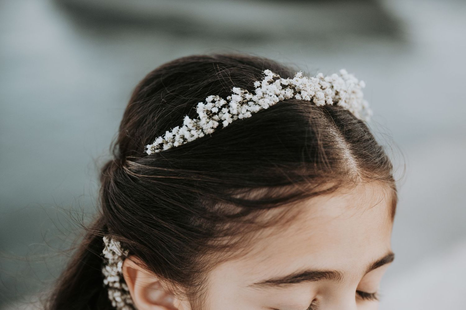 Delicate silver tiara with crystal details adorning a bridal hairstyle.