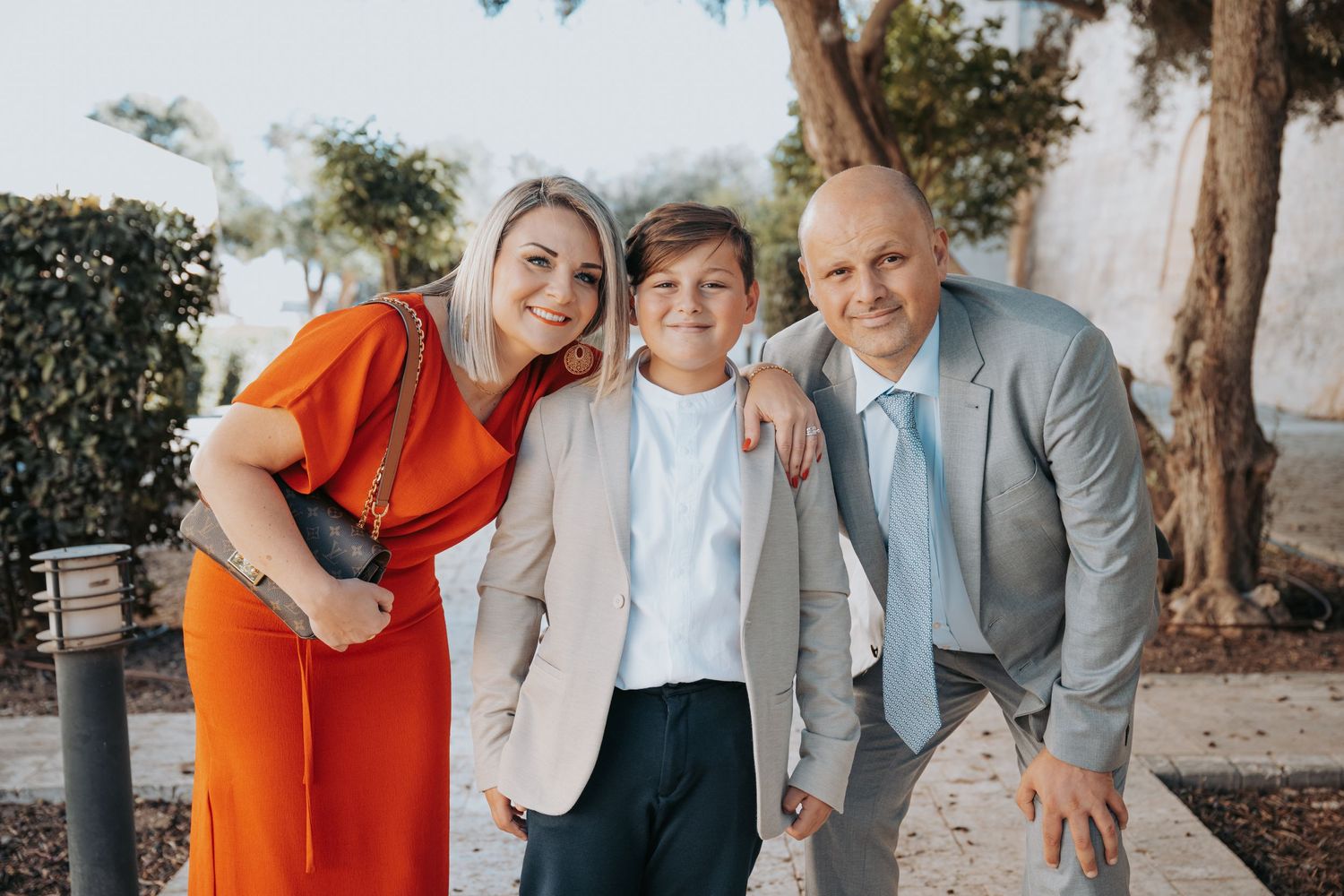 Family members in coordinated outfits share joyful moments together outdoors.