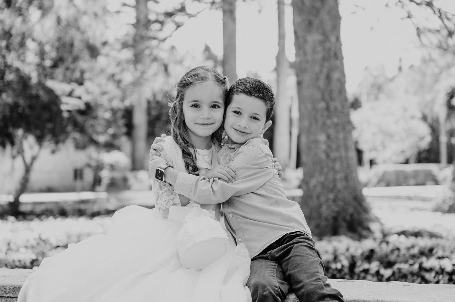 Black and white candid moments captured in an outdoor park setting.