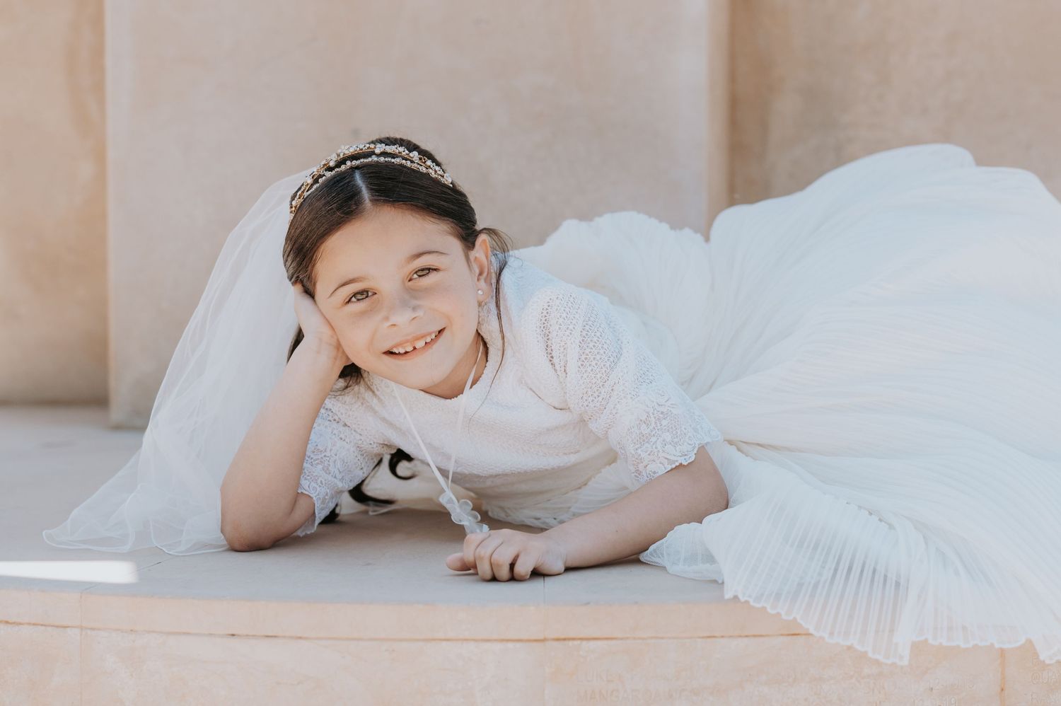 A series of intimate photos showing a bride resting on white bedding.