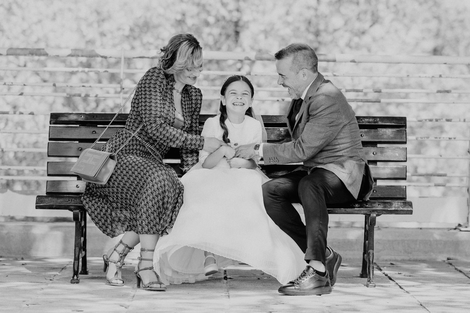 Black and white photos showing a couple sitting and interacting on park benches.