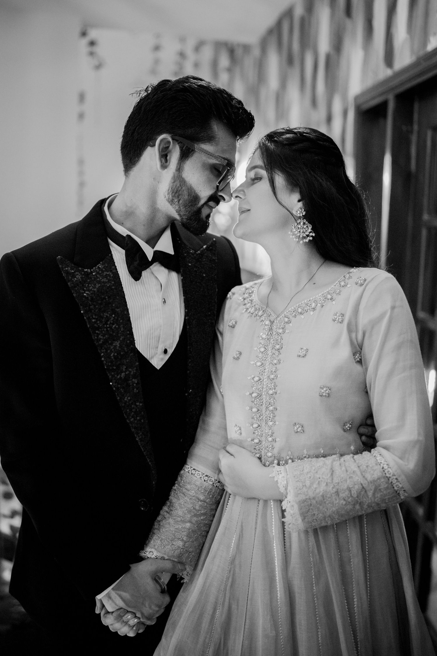 A romantic black and white photo series showing tender moments between a couple on their wedding day.