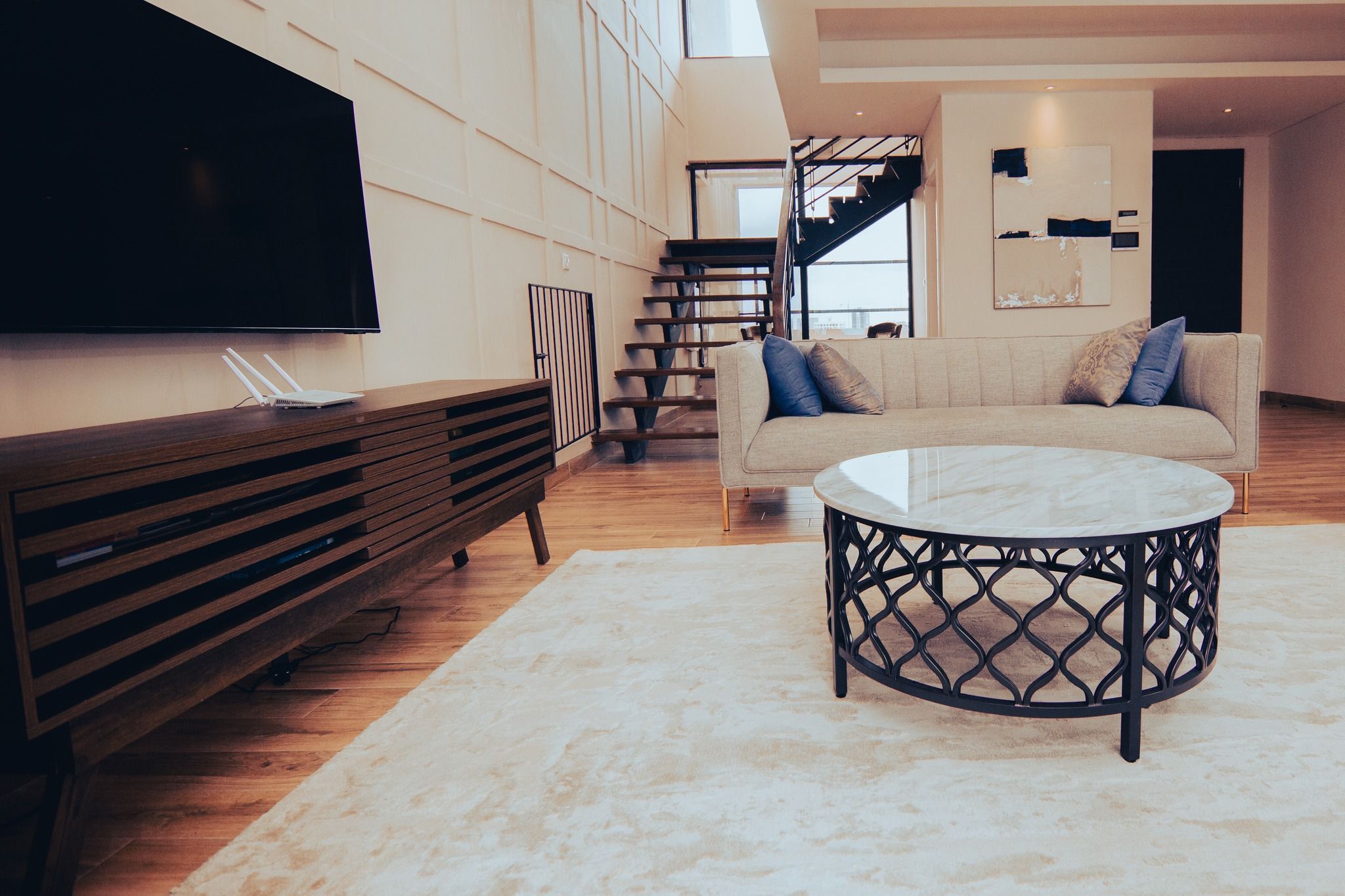 Luxurious open-concept room with dark wood accents and marble flooring.