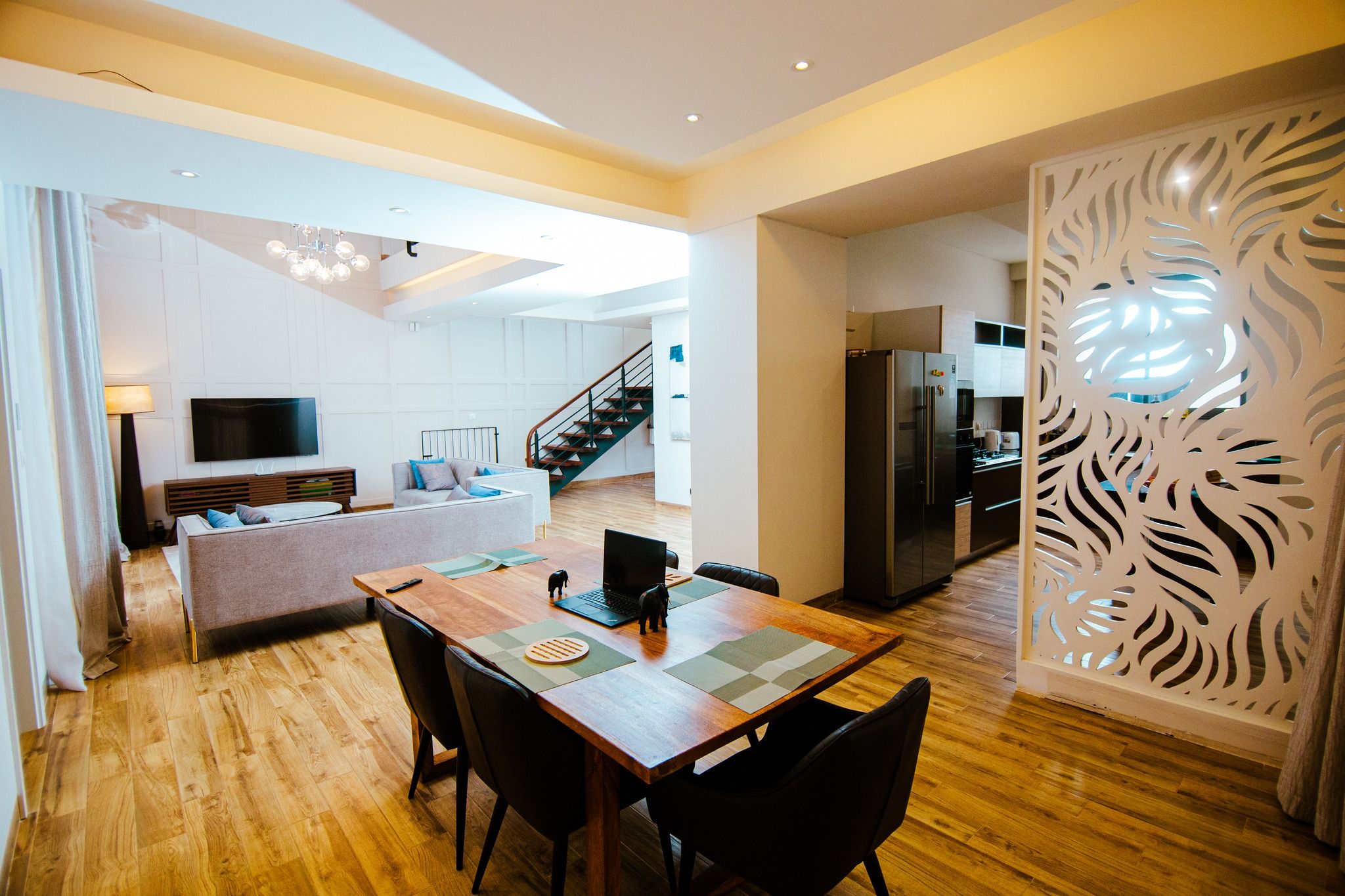Contemporary living space with yellow accent ceiling and zebra-print wall art.