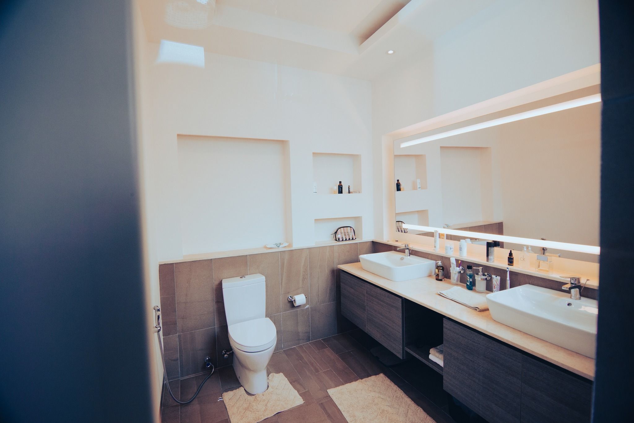 Modern bathroom featuring dark cabinets and minimalist fixtures.