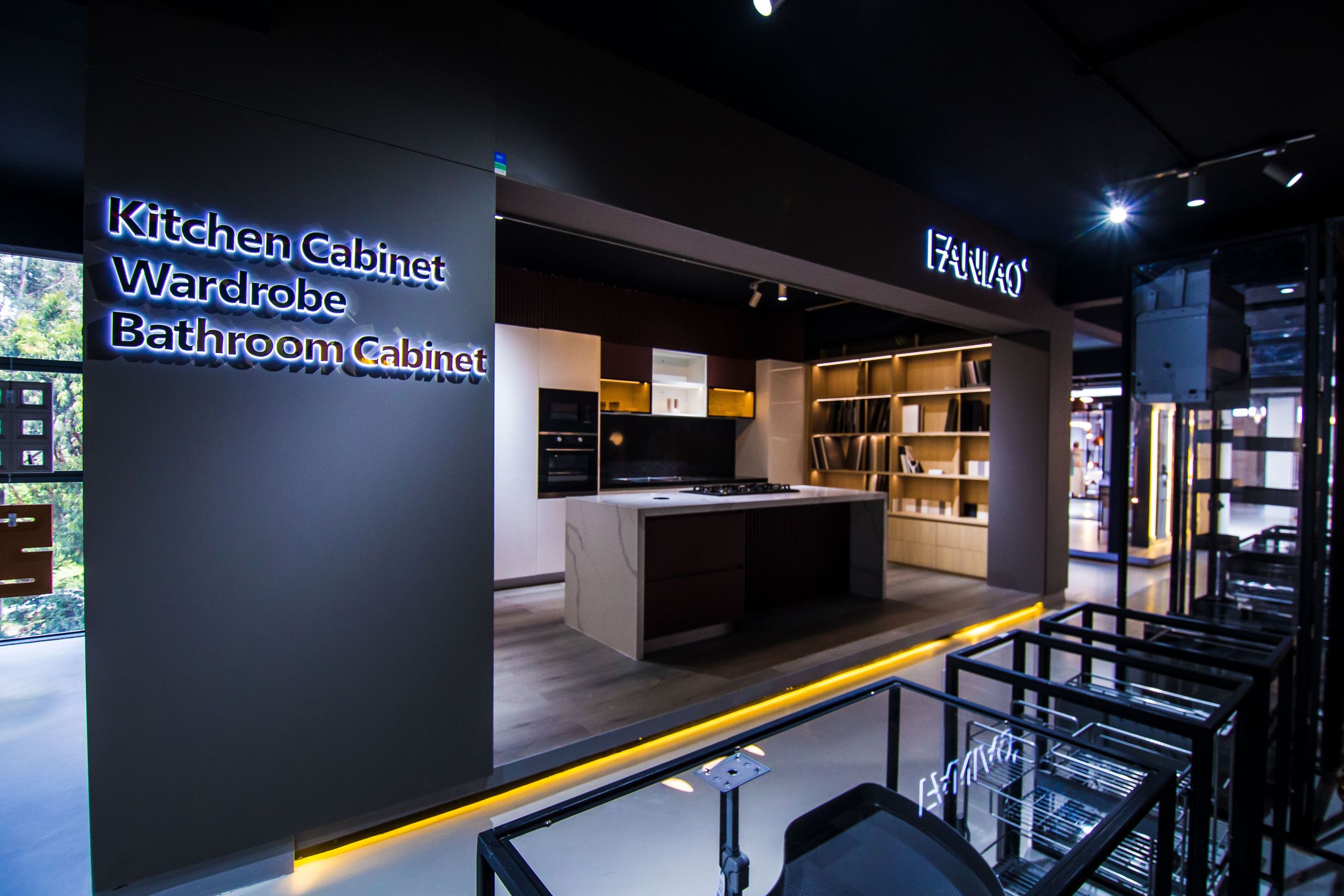 Dark showroom corridor with illuminated signage and modern retail displays.
