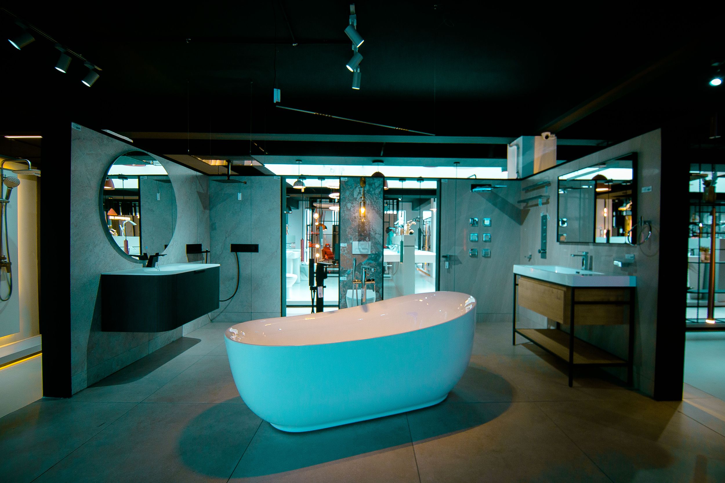 Curved reception desk illuminated with blue lighting in a modern office lobby.