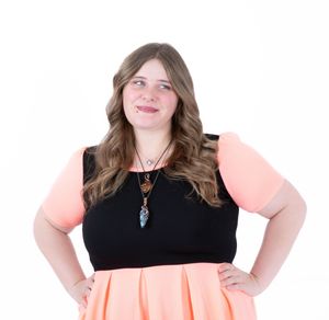 A person in a black top and coral skirt stands confidently with hands on hips in multiple poses.