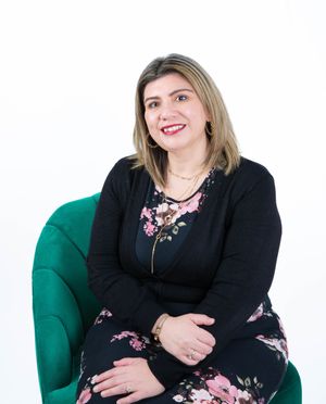 Professional portrait series showing woman in floral dress and black cardigan posing on emerald green chair.