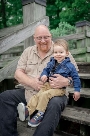 A series of candid outdoor photos showing tender moments between two people sitting on wooden steps in a park setting.