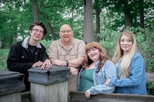 A series of outdoor family portraits showing people sitting and posing together on a wooden fence in a green forest setting.