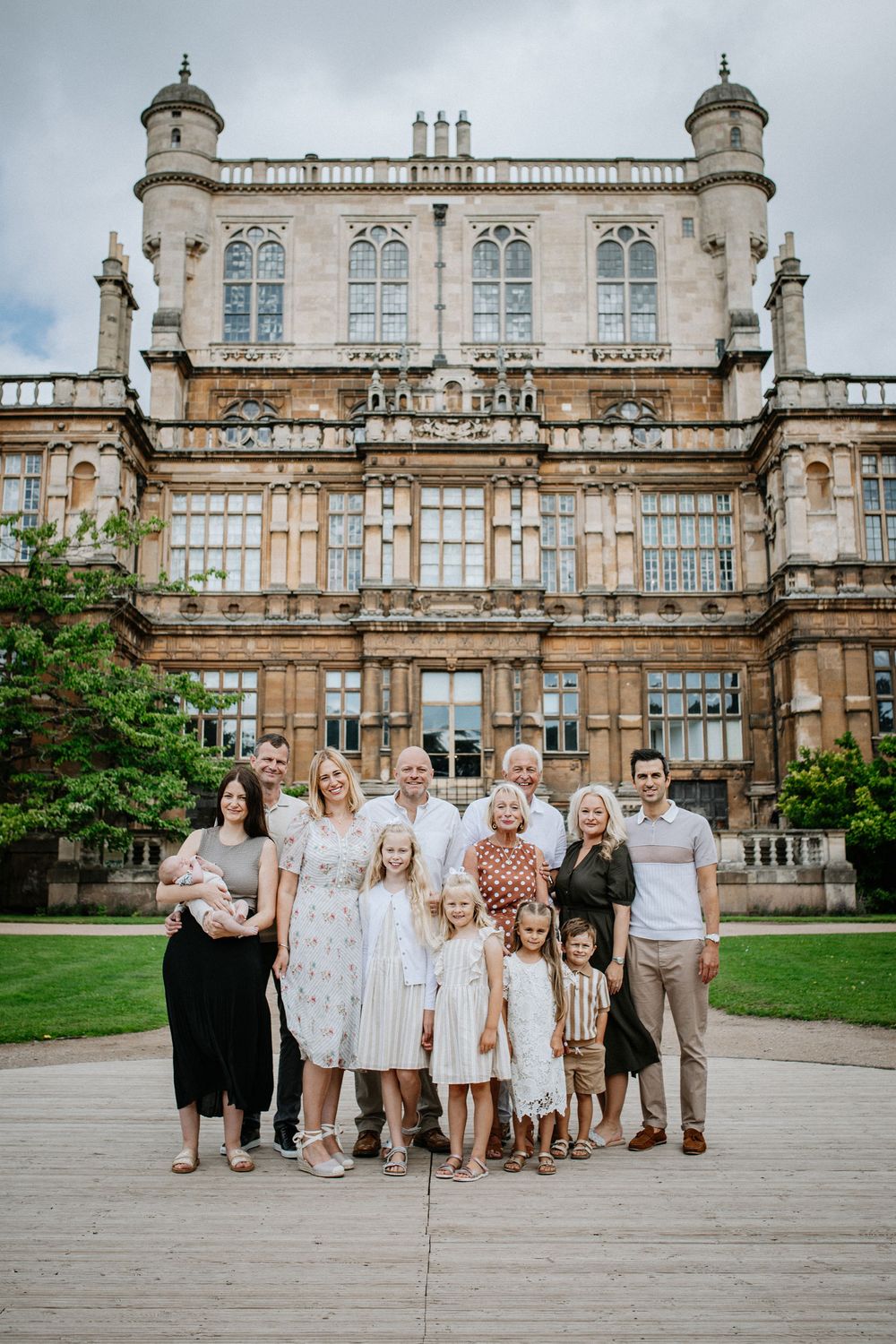 Family photoshoot standing together in front of Wollaton Hall in Nottingham