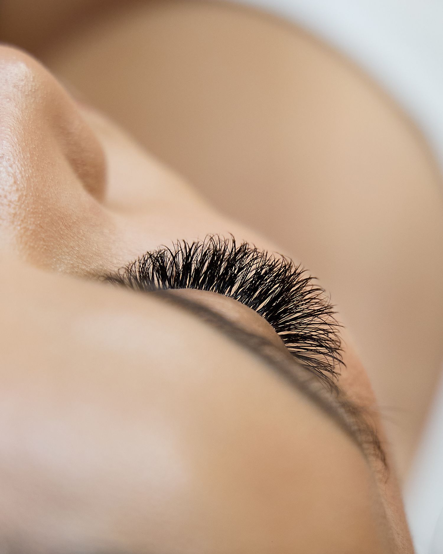 Extreme closeup of long dark eyelashes showing professional makeup application.