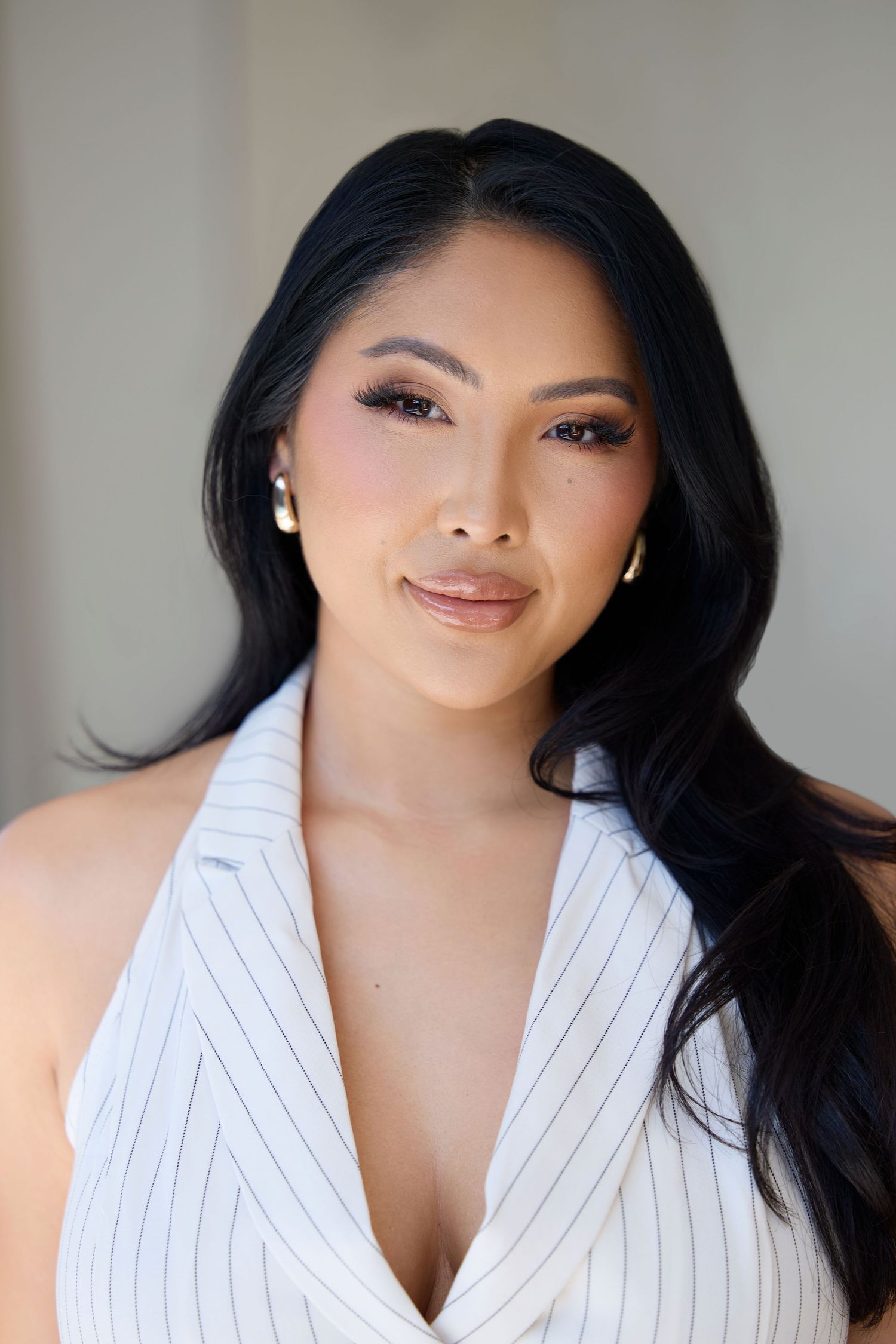 Glamour portrait series in white pinstripe blazer showing different angles and expressions.