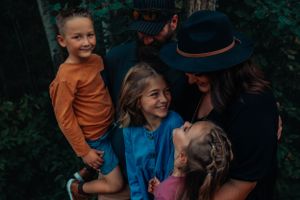 An intimate outdoor moment captured between a group in natural surroundings.