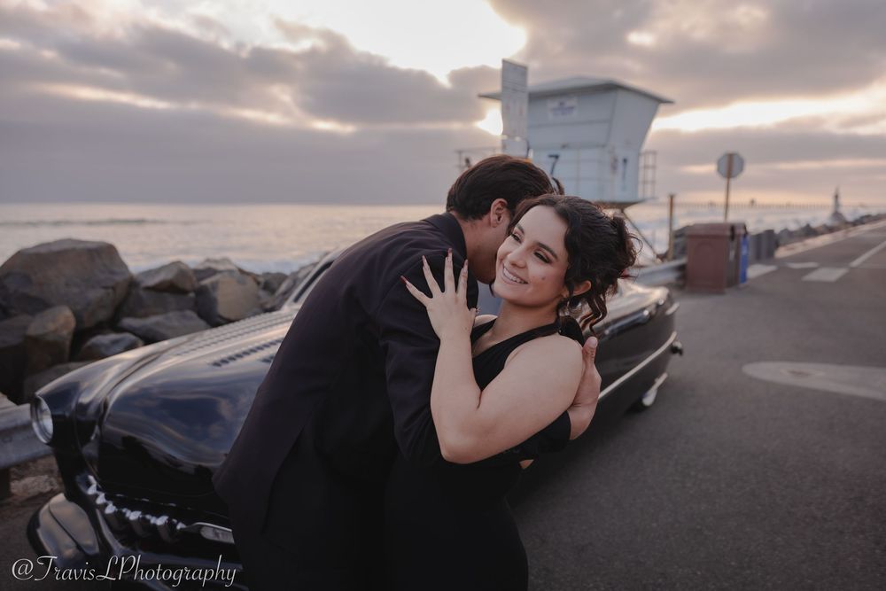 Couple in formal wear sharing tender moments during golden hour by the coast.