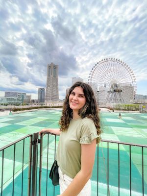 A photo of Brenna in Yokohama, Japan in front of a ferris wheel