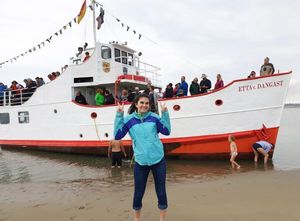 A photo of Brenna in front of a large boat in Danggast, Germany