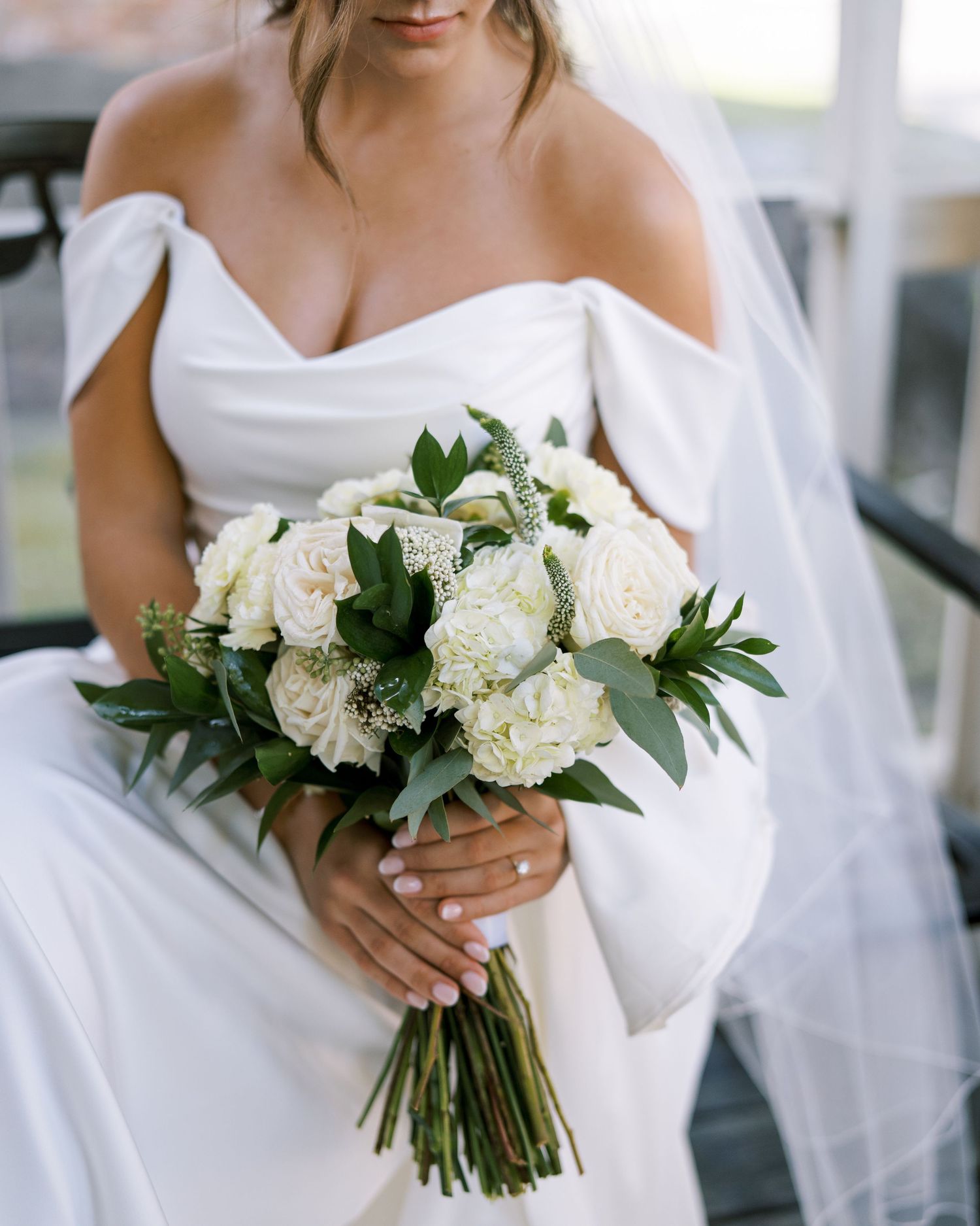 Classic white bridal bouquet with roses, peonies and eucalyptus greenery.