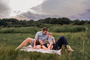 A peaceful moment on a blanket in a summer meadow at dusk.