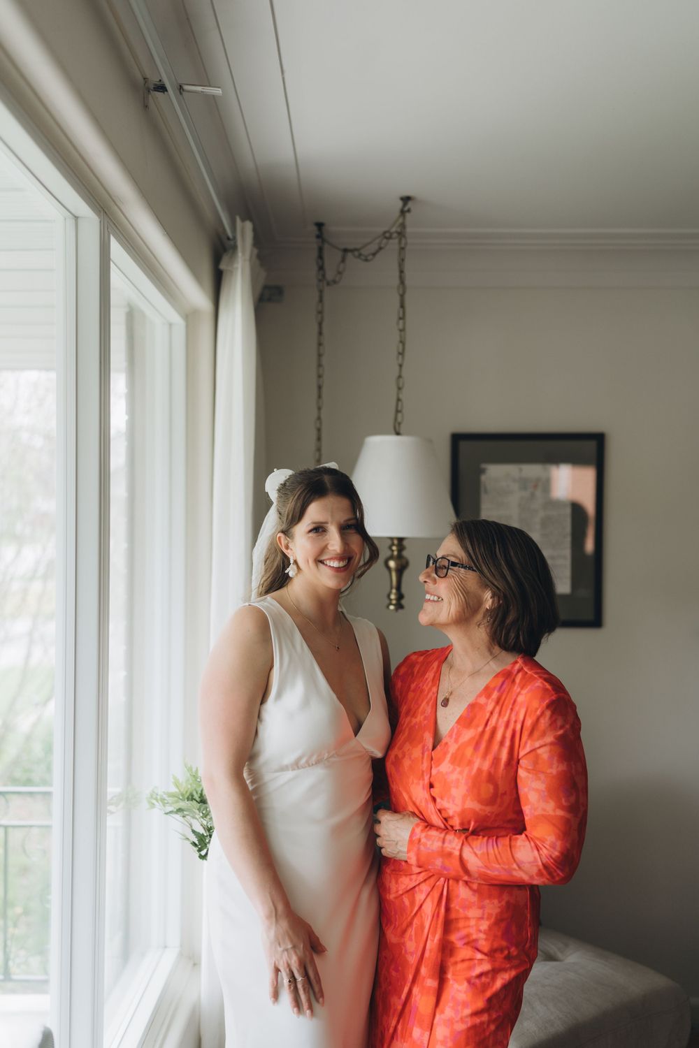 Intimate moment captured by window light in an elegant interior setting.