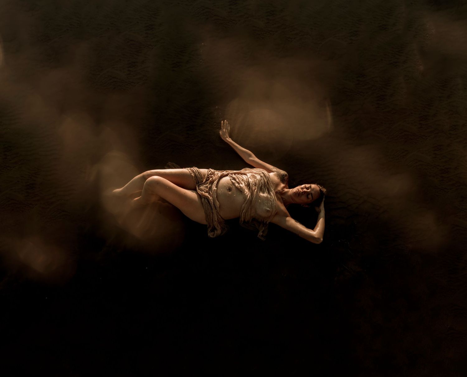 A brown grasshopper in mid-jump silhouetted against a dark background with dramatic lighting.