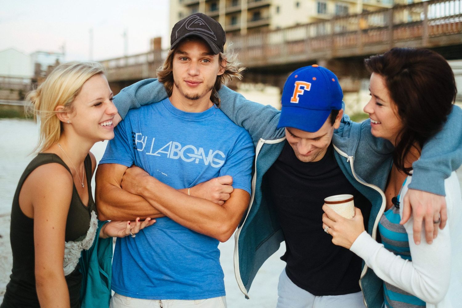 Group of friends hanging out together casually dressed in athletic wear outdoors.