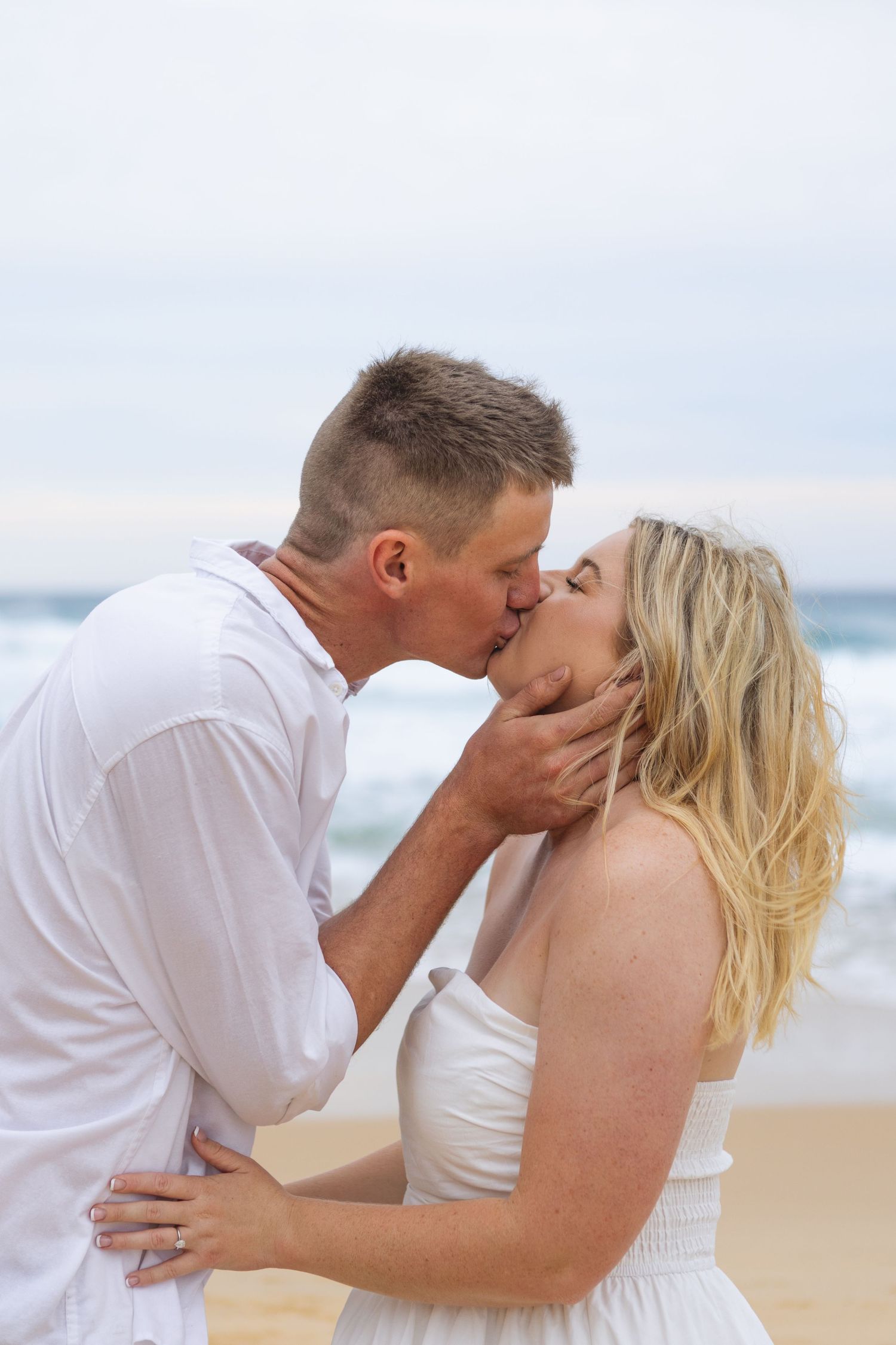 Couple cuddling during engagement photoshoot