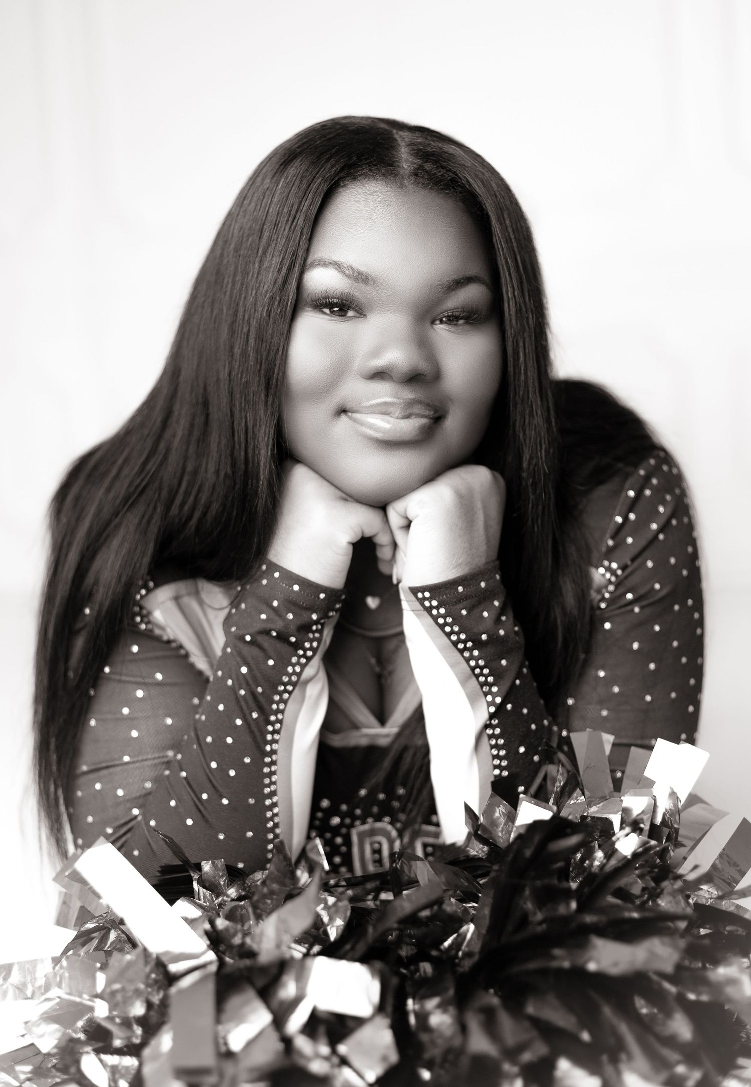 Glamour portraits with person in sparkly black dress against white backdrop.