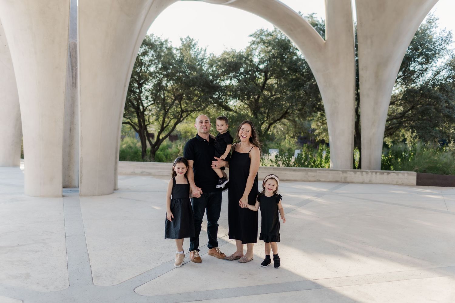 Group photo under white architectural archways during sunset,, by best San Antonio Photographer.