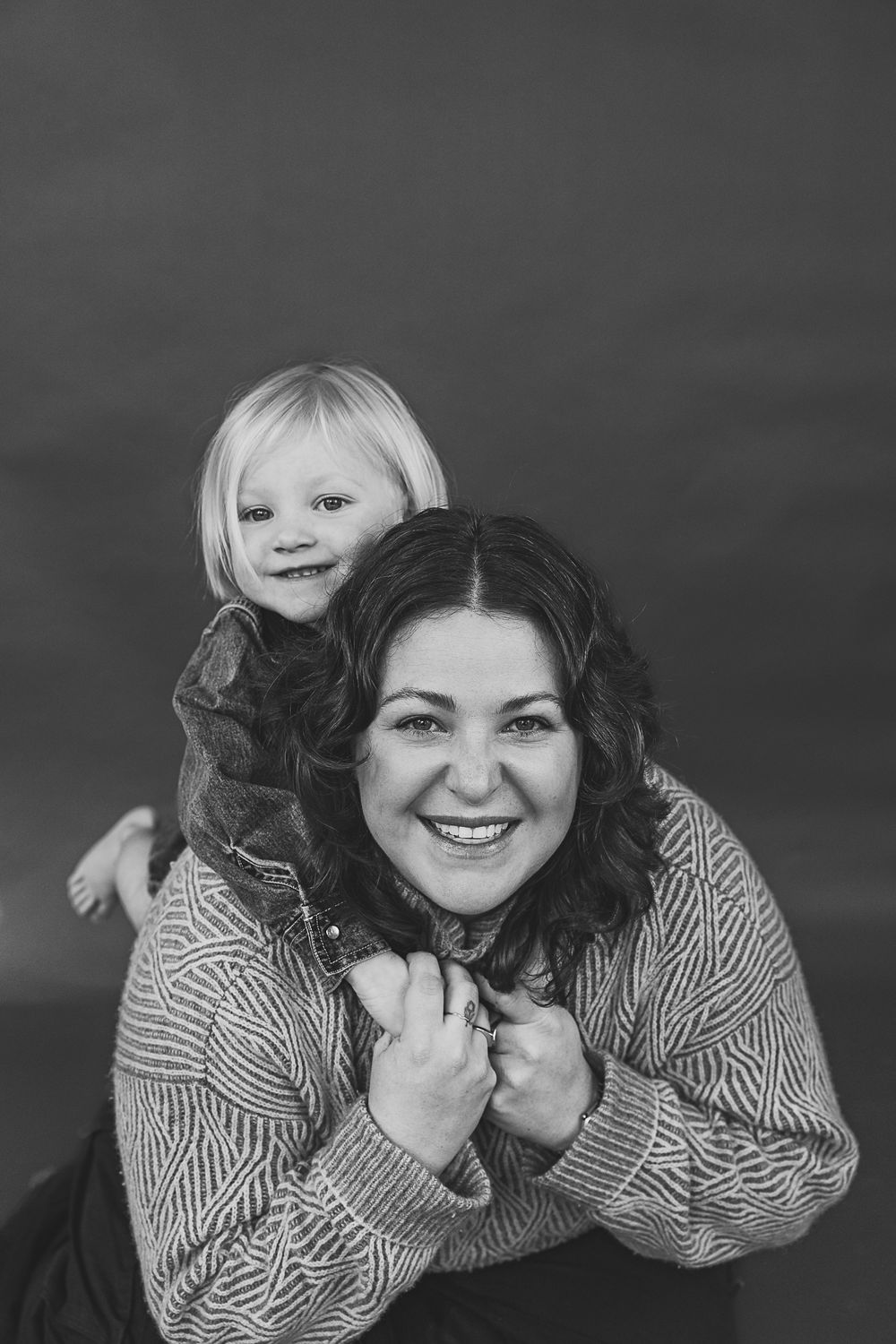 A black and white photo sequence showing someone lying down and making playful expressions in a striped shirt.