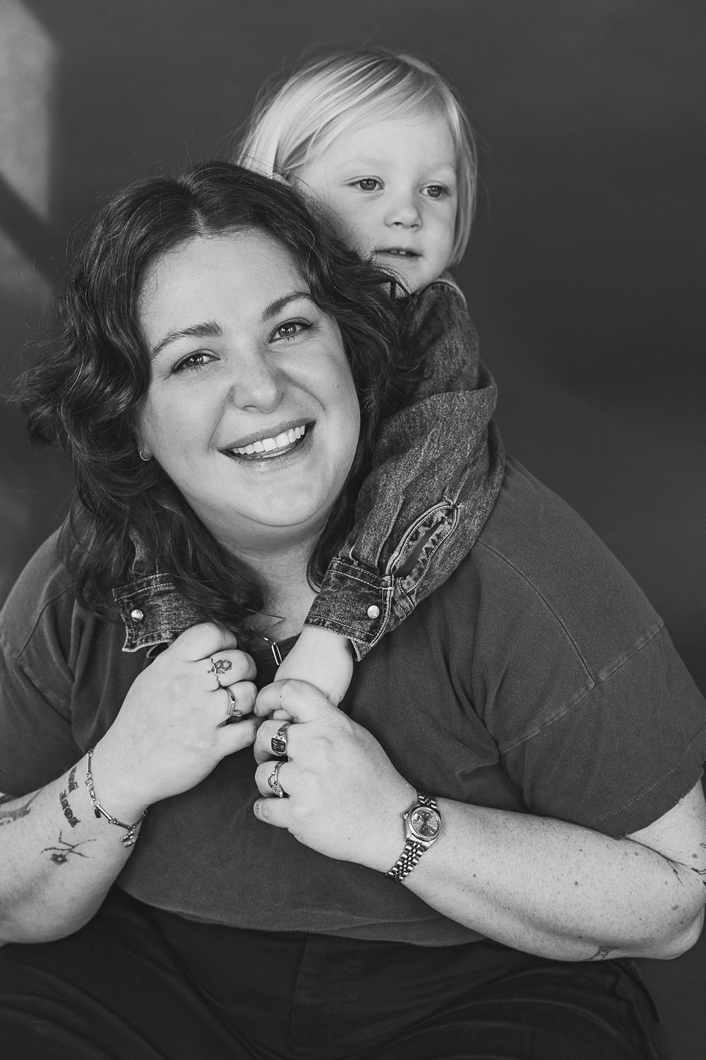 Black and white studio photographs capturing intimate moments and genuine smiles in a casual setting.