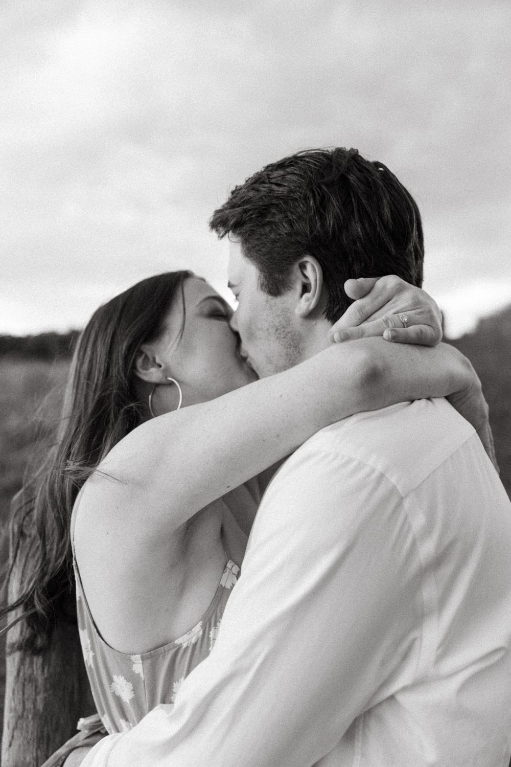 Black and white photos of a couple embracing in a tender moment.