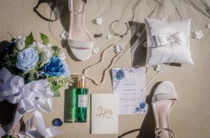 Wedding details and decorations arranged on a light colored surface.